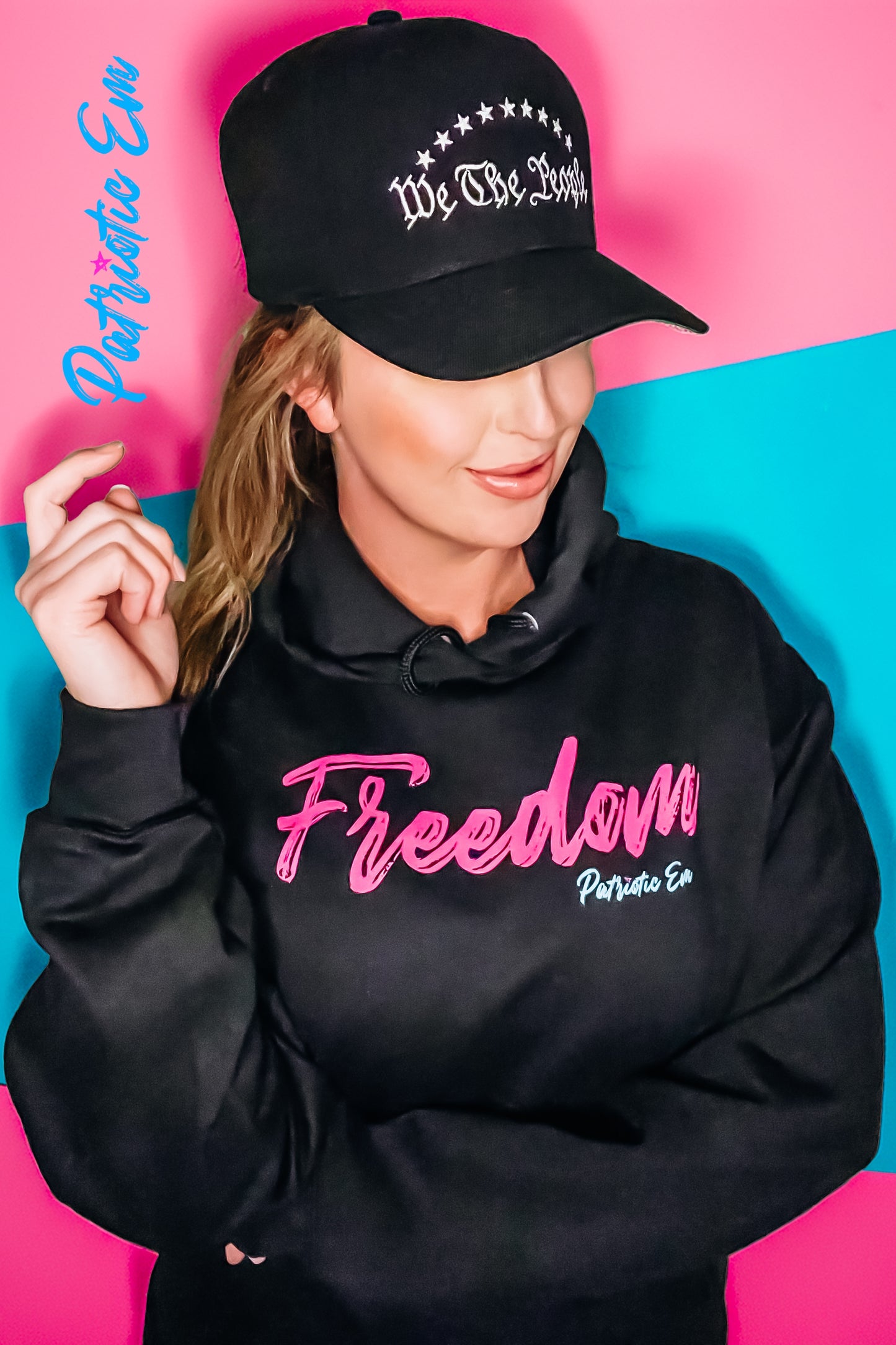 Close-up of FREEDOM print in vibrant pink ink on soft black fabric